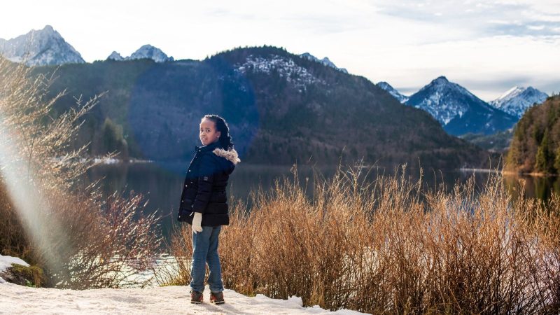 A woman standing quietly in a mountain landscape