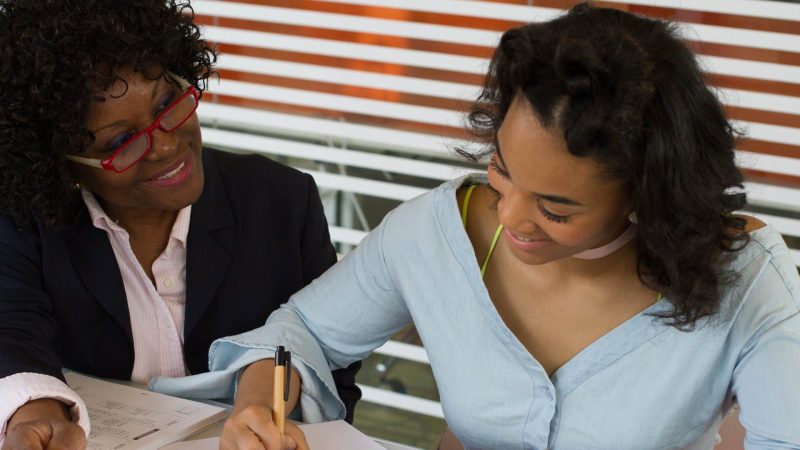 A leader mentoring a younger woman