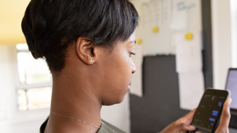 A woman sending a message on her phone