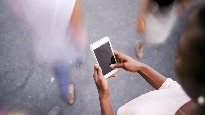 A listener requesting a song from her phone